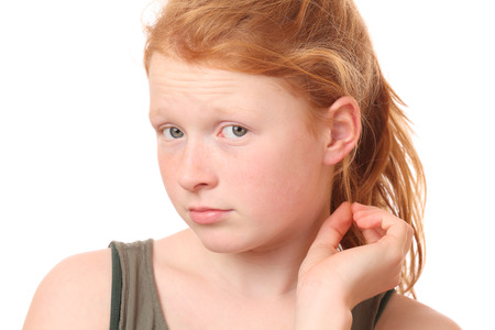 Portrait of a thoughtful teenage girl on white backgroundの写真素材