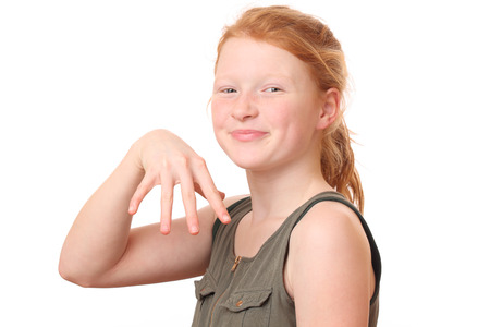 Portrait of a happy teenage girl with red hair on white backgroundの写真素材
