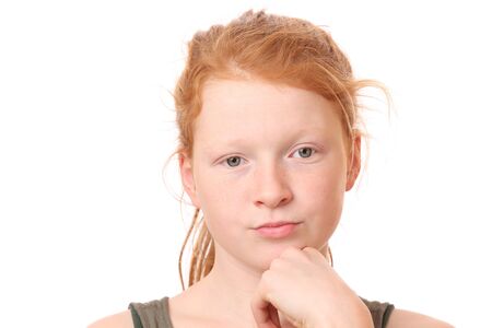 Portrait of a thoughtful teenage girl on white backgroundの写真素材