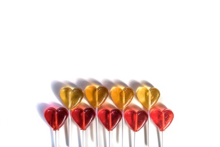 Lollipops candy sweets. Red and yellow hearts. Love concept. Valentine day. isolated on white background. Placed in two rows.の写真素材