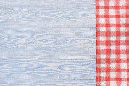 Red towel over wooden kitchen table. View from above with copy space.の写真素材