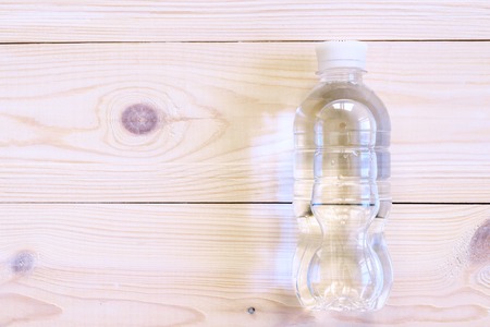 Bottled water on the wooden table, top view. Flat lay. Helth and fitness concept.の写真素材