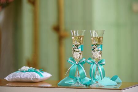 wedding stemware with champagne on wooden glossy tableの写真素材