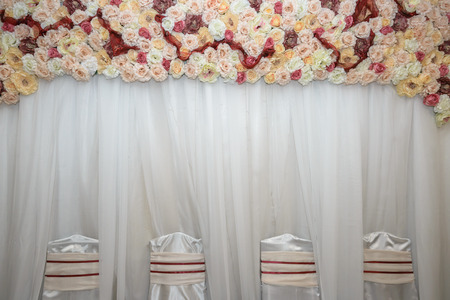 beautiful white wedding chairs decorated with purple bows.