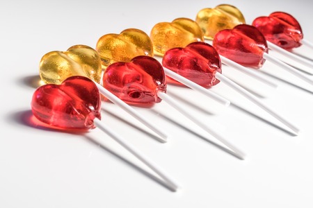 Lollipops candy sweets. Red and yellow hearts. Love concept. Valentine day. isolated on white background. Placed in two rows.の写真素材