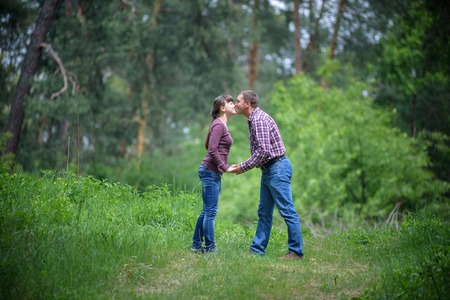 attractive couple with crystall ball hands holding together looking to each other kissingの写真素材