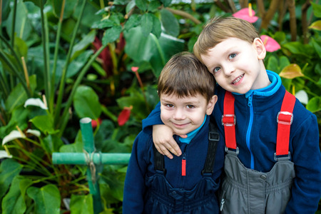 Portrait of two boys, siblings, brothers and best friends smiling. Friends hugging. Happy kids...