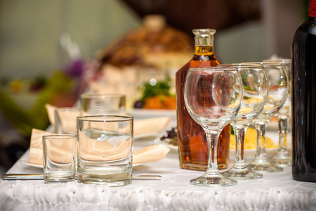 Beautiful table setting with crockery and flowers for a party, wedding reception or other festive event. Glassware and cutlery for catered event dinner.の写真素材