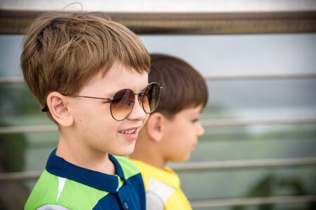Close Up Face with Smiling Kid Portrait, Happy Boy in Sunglases Enjoying Summer Holidays Closeup, Summer Outdoors, Funny Kid Wearing Sunglasses, Summer Fun, Summertime, Summer Fun Kids.の写真素材
