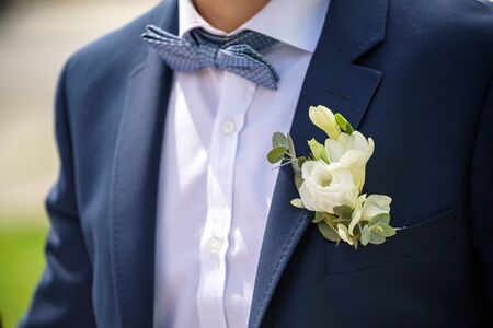 groom in a jacket, boutonniere on a jacket, the groom adjusts his jacket, The morning of the groom, business style, man in a jacket.の写真素材