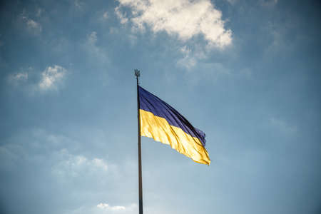 Ukrainian blue and yellow flag on the sky background.