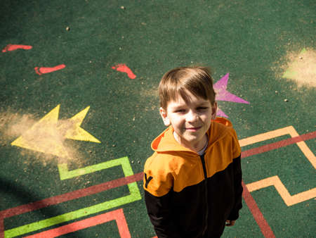 Boy playing on the playground, in the children's maze. children's slide.