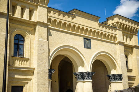 07 August 2021, Kyiv, Ukraine - Close-up of ancient building in Kyiv with Coat of arms of Kyiv symbol logo of archangel Michael.のeditorial素材