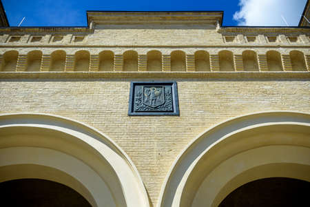 07 August 2021, Kyiv, Ukraine - Close-up of ancient building in Kyiv with Coat of arms of Kyiv symbol logo of archangel Michael.のeditorial素材