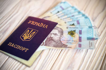 New banknotes in denominations of 1000 hryvnia with a Ukrainian passport. Ukrainian money. Business concept. Background with hryvnia.の写真素材