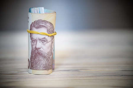 new Ukrainian hryvnia. 1000 hryvnia on wooden table bind with rubber tape to tube. money background...