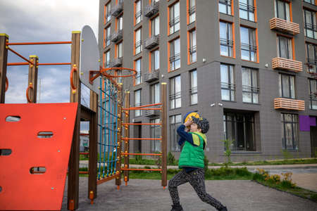 Portrait of a boy with a basketball on a basketball court. The concept of a sports lifestyle, training, sport, leisure, vacation.の写真素材