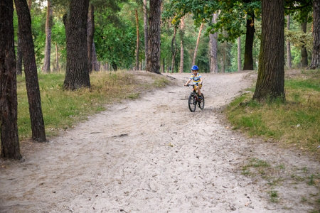 Cyclist Riding down the sandy Hill on the Offroad Trail.の写真素材