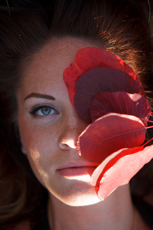 Girl with leaves lying
