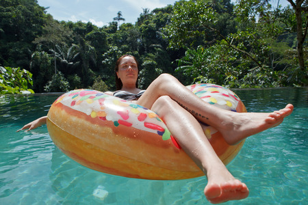 girl in the pool at inflatable ring