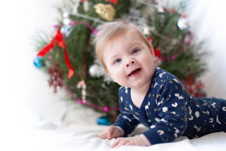 infant near christmas tree new yearの写真素材