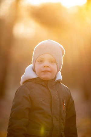 boy in a jacket smile in the autumn streetの写真素材