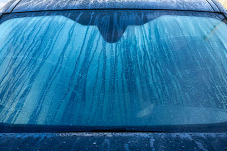 Condinsation on car windscreen. Running water on Black car windscreen.の写真素材