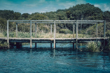 Small wooden bridge. small unstable wooden bridge over a stream in a country park.