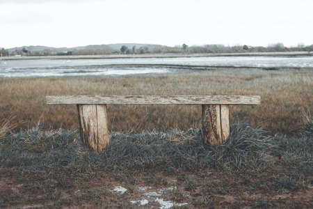 Wooden bench. Isloated bench in Prinstead overlooking the sea. winter adventure hiking in Prinstead.の写真素材