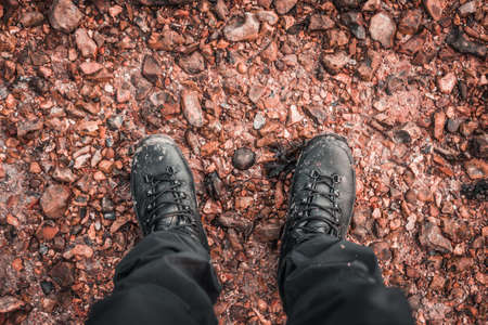Muddy Boots. Point of view of muddy hiking boots in a muddy puddle. winter adventure hiking around Prinstead.の写真素材
