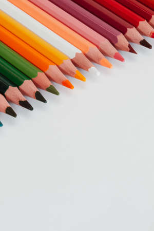 Close up of sharp colored pencils. Coloured penciles used for home schooling lined up during art lesson.の写真素材