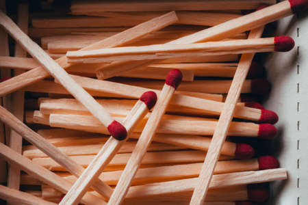Box of wooden match sticks with red tips in the box. Multiple matches with red ends in a cardboard box.の写真素材