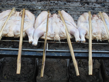Raw chicken on sticks on a grill.の写真素材