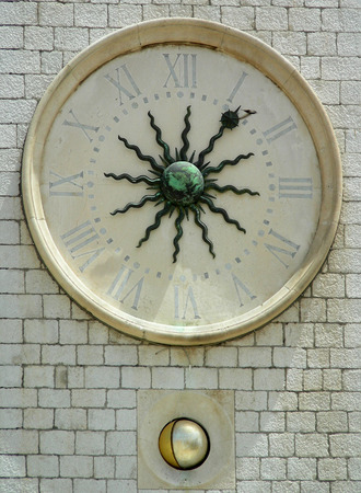 Old clock with roman numerals and moon phases at tower in Dubrovniki, Croatia.         