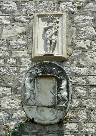 Old bas-relief with coat of arms on building at Trsteno Arboretum, Croatia      の写真素材