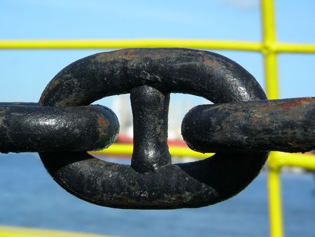 Rusty, black metallic anchor chain on a ship           の写真素材