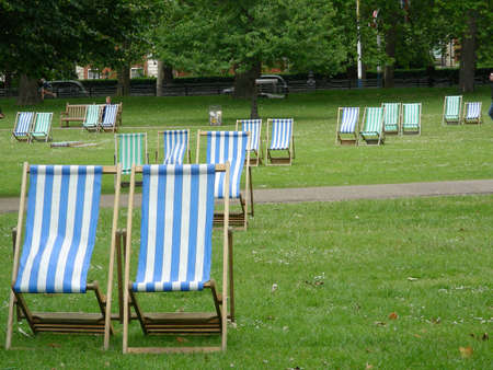 A colourful deck chairs in London park          の写真素材