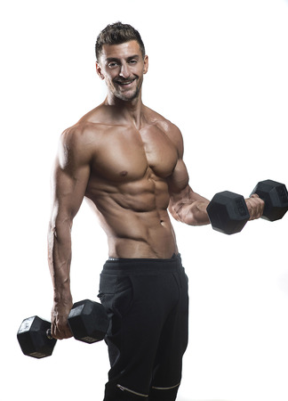 mature athlete posing with dumbells, dramatic lighting on white backgroundの写真素材