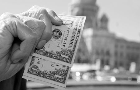 Senior showing money by the Capitolの写真素材