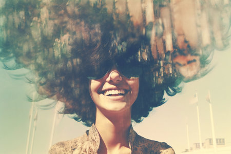 Portrait of a beautiful woman with curly hair and a smile.の素材