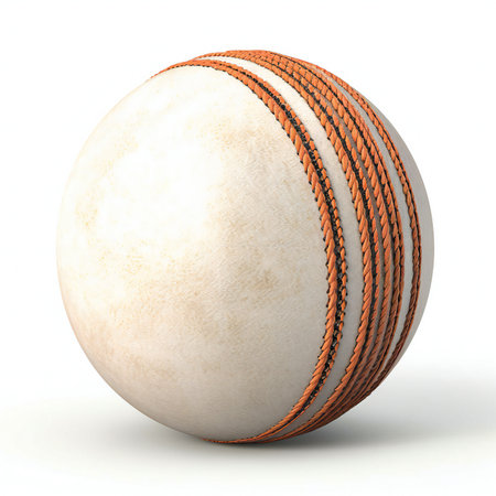 a white cricket ball with orange stitching isolated on white backgroundの素材