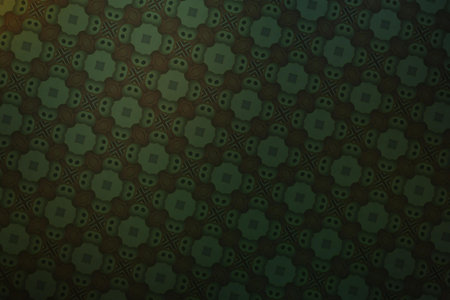Textile cloth black and green with a kaleidoscope pattern.