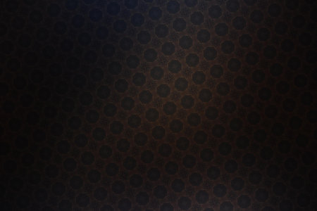 abstract background of black and brown metal with some holes in itの写真素材