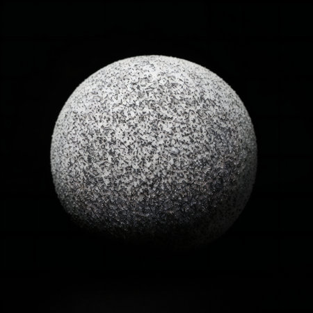 A closeup shot of a stone ball on a black background.の素材
