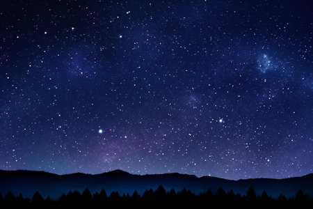 Night sky with stars and milky way over forest and mountains.の素材