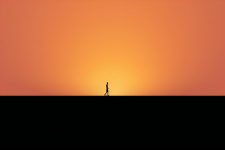Silhouette of a man walking on the roof at sunset.の素材
