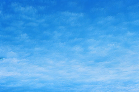 Blue sky background with tiny cloudsbe used as background.の素材