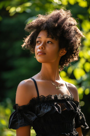 Beautiful african american woman with afro hairstyle outdoorsの素材