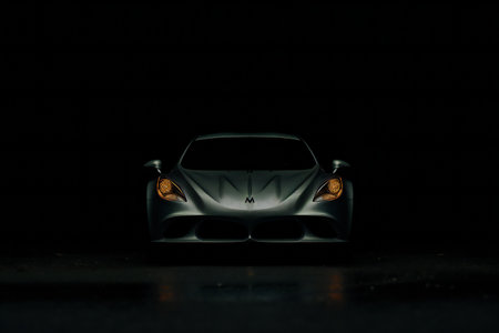 Close up shot of a sports car on a black background with backlightの素材