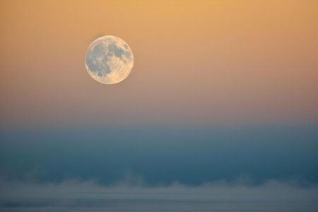Moon over the sea. Beautiful nature background. Full moon at sunset.の素材